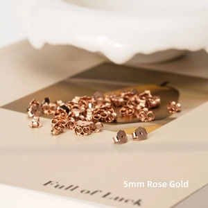 Close-up of 5mm rose gold S925 sterling silver earring backs on an aesthetic background