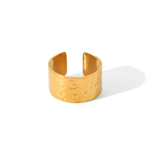 Detailed view of wide 18K gold plated ring with a hammered texture and open adjustable band