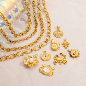 18K gold plated stainless steel sea themed pendants and chains set on beige background