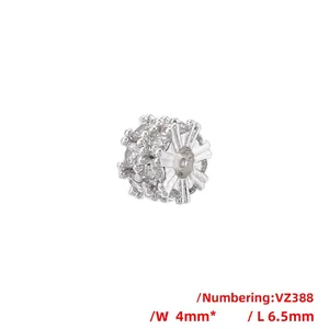 Macro detail of silver bead charm with sparkling cubic zirconia pavé and hollow eye design