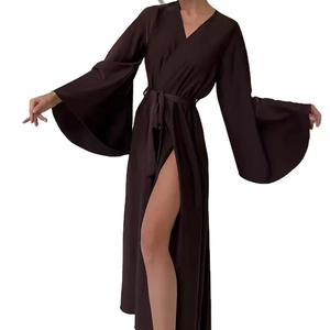 Detail of dark brown satin wrap dress with oversized bell sleeves and high leg slit