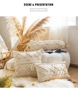 Detail of beige bohemian cushion covers with decorative tassels in a cozy home setting