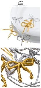 Macro detail of gold and silver butterfly charms in smooth and twisted metal textures