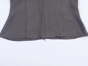 Detailed view of dark gray fabric hem featuring a hidden zipper and precise stitching
