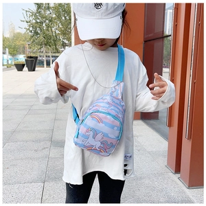 Girl wearing a light blue unicorn chest bag with rainbow patterns and adjustable strap