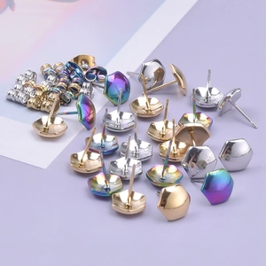 Macro detail of geometric pentagon stainless steel stud earrings in gold, silver, and rainbow