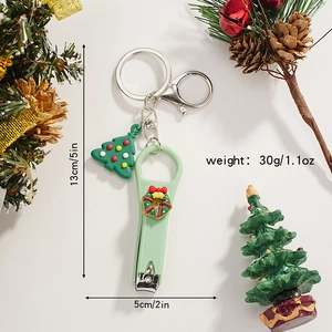 Christmas Santa nail clipper keychain with festive tree charm and green casing