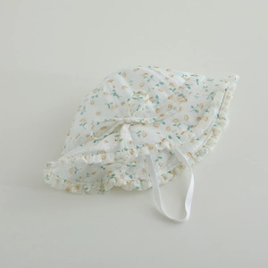 Detailed close-up of floral baby sun hat with lace brim, bow, and elastic strap