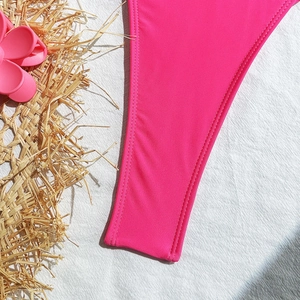 Detailed close-up of hot pink swimsuit fabric with high-quality double-needle stitching