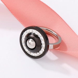 Macro view of silver stainless steel ring with black enamel and sparkling white crystals