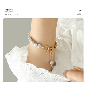 Detail of gray freshwater pearl bracelet with gold brass chain and OT clasp on lace cuff