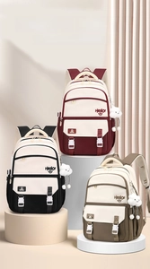 Close-up of color-block backpacks in three colors with cloud charms and hello graphics