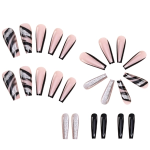 Detail of long coffin press-on nails with pink zebra stripes and silver glitter accents