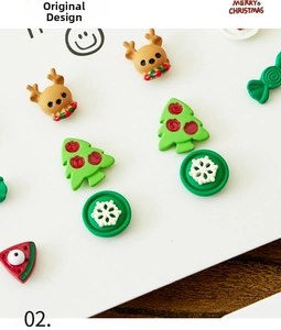 Detail of Christmas earring set elements featuring reindeer, tree and snowflake charms
