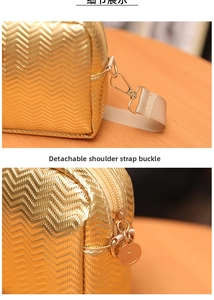 Detail of golden wave-textured camera bag featuring metal zipper and detachable strap