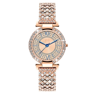 Luxurious rose gold women watch with rhinestone bezel and blue hands on white background