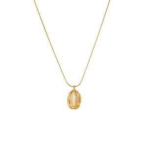 Detail of gold snake chain necklace featuring a hammered oval moonstone pendant