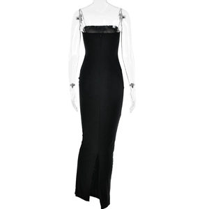 Close-up of black bodycon dress back with metal chain straps and elegant split hemline