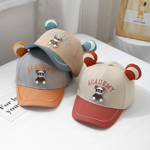 Detailed close-up of toddler baseball caps featuring cute bear ears and Academy embroidery