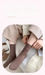 Close-up of brown ribbed knit socks with loose fit cuffs for cozy winter home wear