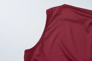 Detailed close-up showing the professional stitching and smooth burgundy fabric of the top
