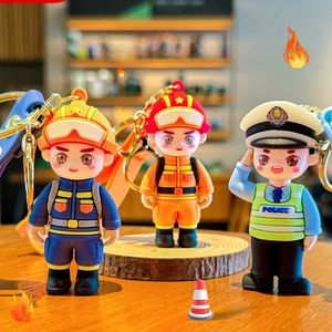 Cartoon firefighter and police PVC keychains set displayed on a wooden surface