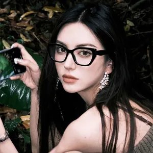 Black cat-eye anti-blue light glasses worn by a female model in an outdoor setting
