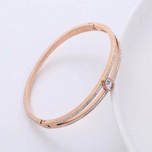 Rose gold stainless steel bracelet with double-row crystals and central zircon stone