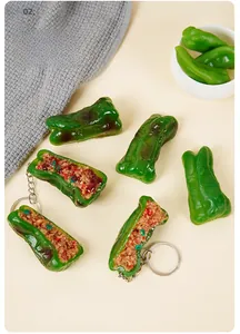 Close-up of realistic PVC tiger skin green pepper keychain with detailed meat filling texture