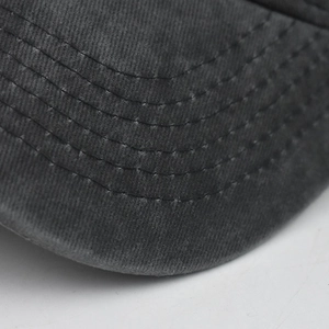 Detail of the washed cotton baseball cap brim showing six rows of reinforced stitching