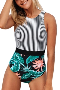 Detail of high-neck swimsuit featuring vertical stripes and tropical leaf print