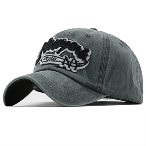 Close-up of deep gray washed cotton baseball cap featuring thick 3D New York embroidery