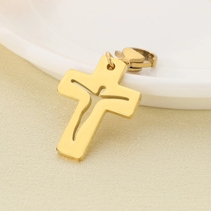 Close-up of golden stainless steel hollow cross pendant with a figure silhouette cutout