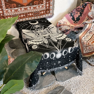Bohemian black and white woven picnic blanket with moth and moon phase patterns