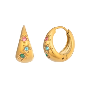 Macro detail of U-shaped gold earrings with colorful star zircon inlays and 18K plating