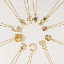 Detailed overhead view of multiple gold chain necklaces with colorful gemstone pendants