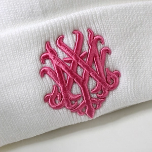 Detail of white ribbed knit beanie featuring premium pink 3D embroidered logo artwork