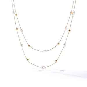 Double-layer necklace with golden chains and irregular freshwater pearls on white background