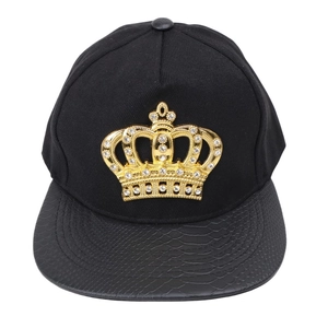 Detail of flat brim snapback featuring gold crown badge and faux snakeskin texture