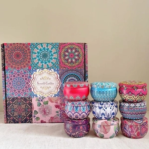 Gift set of nine scented candles in mandala pattern tins with a decorative box