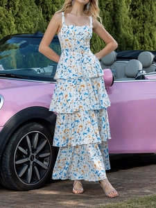 Floral chiffon tiered maxi dress with straps shown next to a pink convertible car