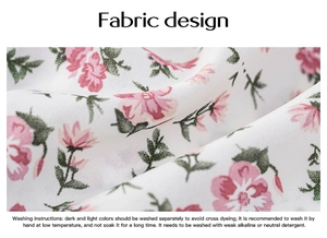 Detailed macro view of soft white fabric with pink floral patterns and washing instructions