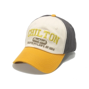 Close-up of vintage 3D embroidery on tri-color cotton baseball cap with high-quality texture