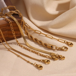 Detail of assorted 18K gold plated Figaro and snake chain textures with lobster clasps