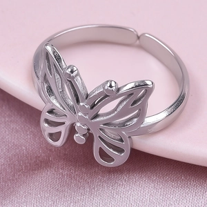 Detail of silver butterfly ring featuring hollow wing texture and adjustable open band