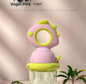 Detail shot of the dinosaur-shaped baby fruit feeder with pink handle and silicone teat