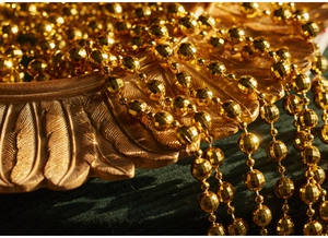 Macro detail of faceted gold beaded star garland chain for Christmas tree decorations