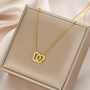 Elegant gold double heart interlocking necklace on satin background for women