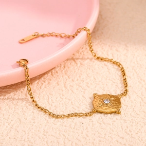 18K gold plated stainless steel bracelet with a hammered square starburst pendant