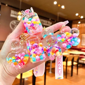 Creative liquid sand keychain with colorful beads and rainbow candy charms in clear shapes
